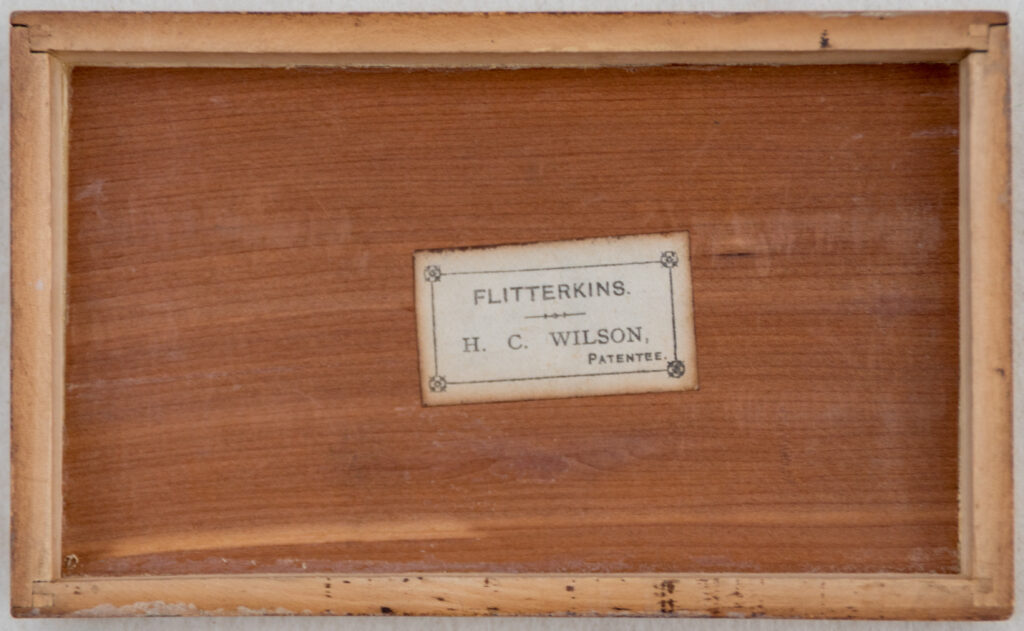 Tucker Tw ID • JAQ-10c1 — AGPI ID • G035104c1 — publisher • J. Jaques & Son (London) — title • THE NEW  GAME of "Flitterkins" — notes • "BY LETTERS PATENT". "TRADE MARK". "PUBLISHED BY J. JAQUES & SON, LONDON.". Mauchline box. — keywords • net, sport, tennis