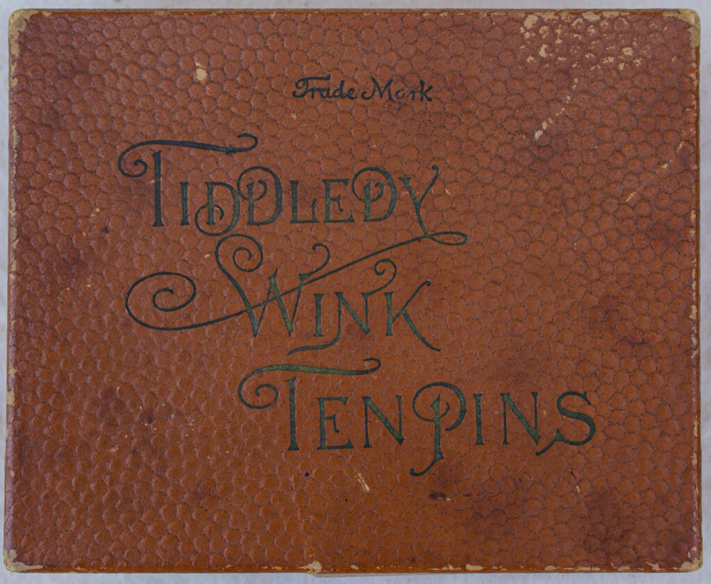 Tucker Tw ID • UNK-010v1c1 — AGPI ID • G-29794c1 — publisher • (not marked, USA) — title • TIDDLEDY WINK TEN PINS — notes • Brown cardboard cover with leatherette texture. "TRADE MARK" above title.