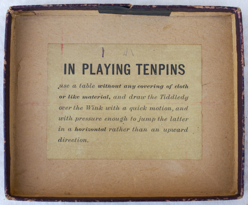 Tucker Tw ID • UNK-010v3c1 — AGPI ID • G-39668c1 — publisher • (not marked, USA) — title • TIDDLEDY WINK TEN PINS — notes • Dark red cardboard cover with leatherette texture. Rules label under box lid.
